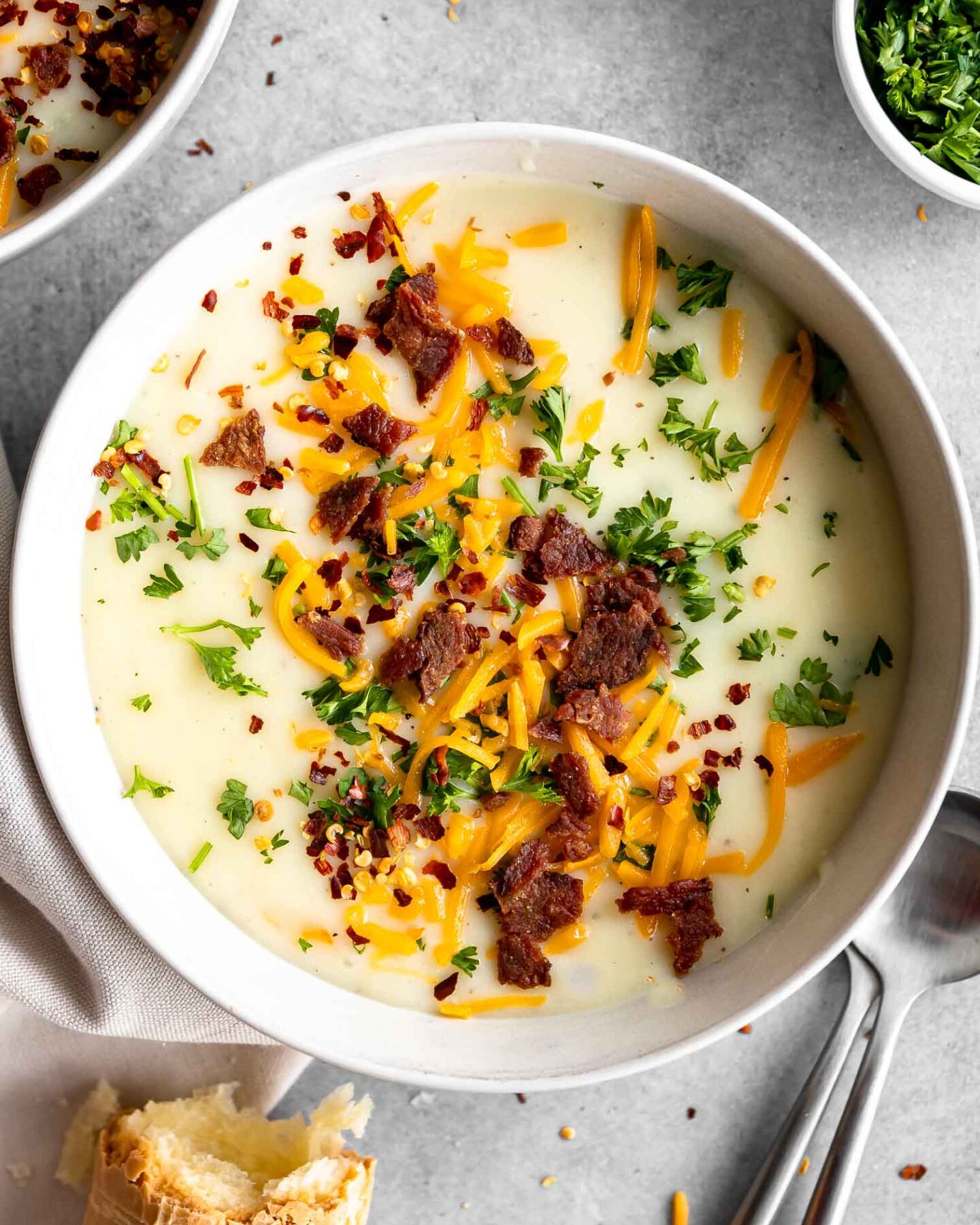 4-Ingredient Potato Soup recipe with bacon bits, cheese, and parsley.
