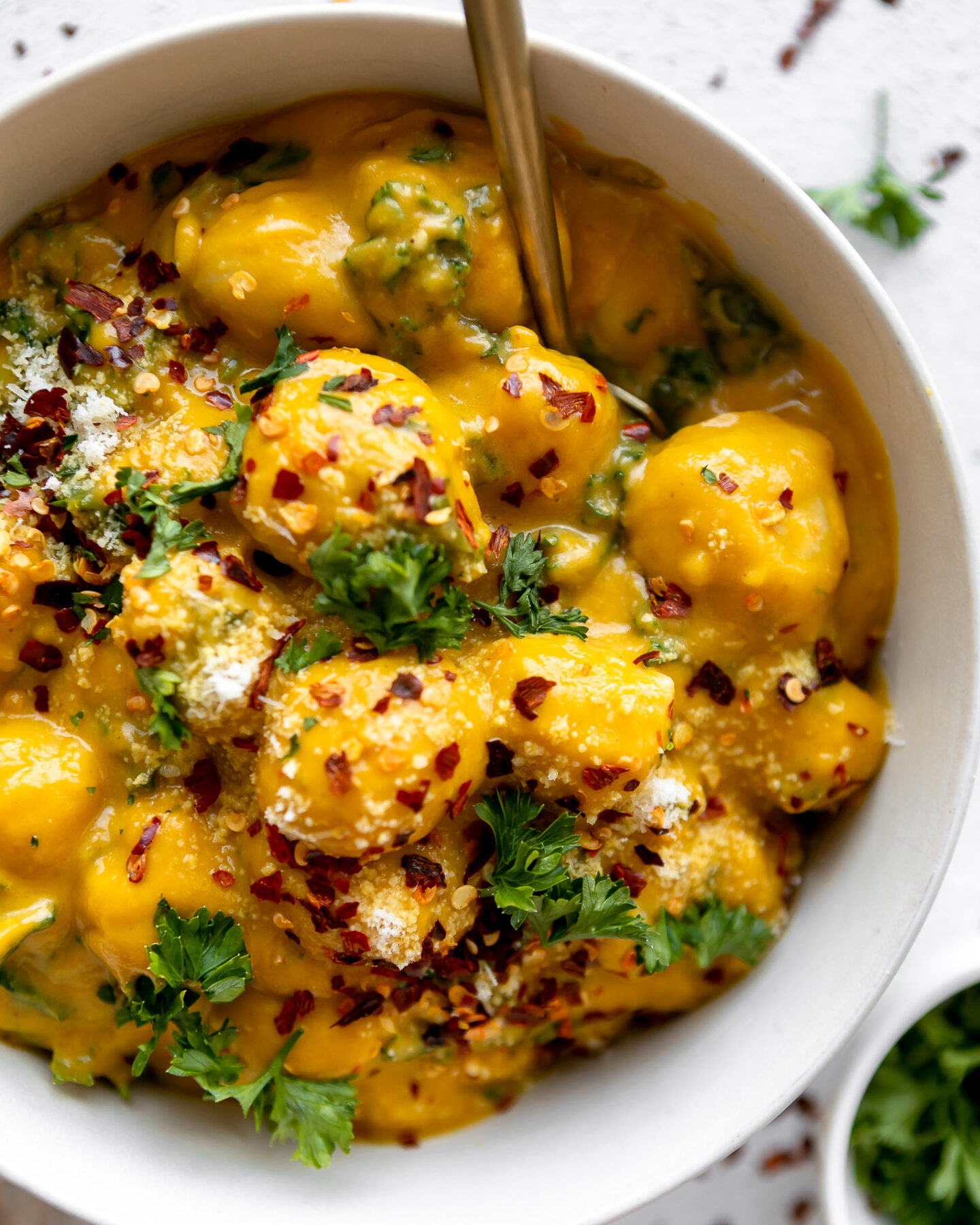 Potato gnocchi with a butternut squash sauce and sautéed kale.