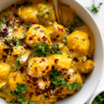 Potato gnocchi with a butternut squash sauce and sautéed kale.