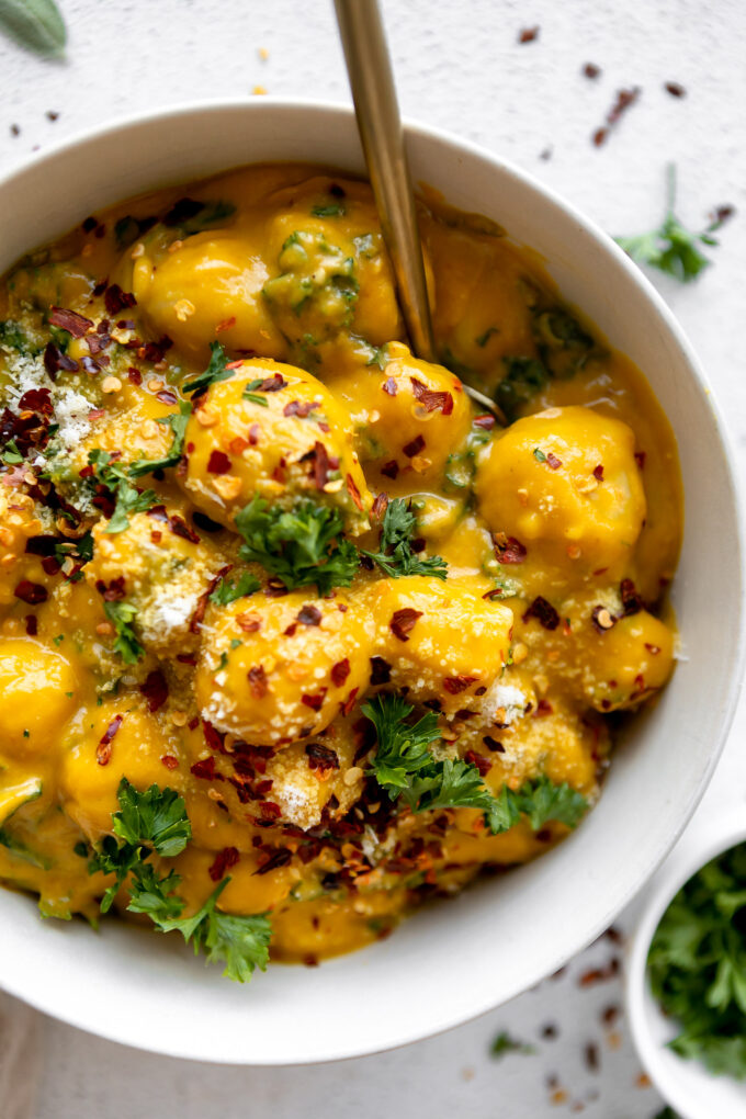 Potato gnocchi with a butternut squash sauce and sautéed kale.