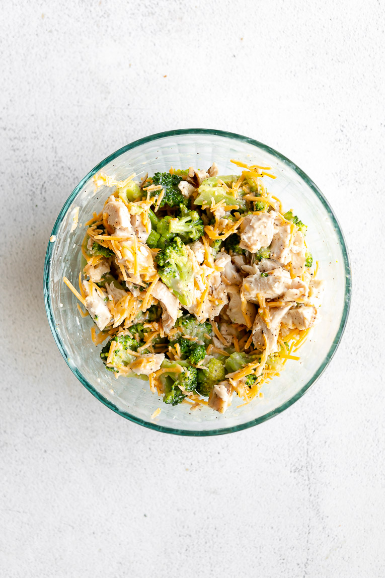 Chicken, broccoli, cream of chicken soup, and cheese in a bowl.
