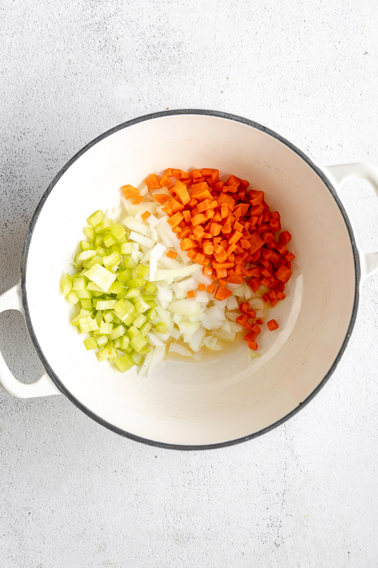Celery, onions, and carrots in a dutch oven.