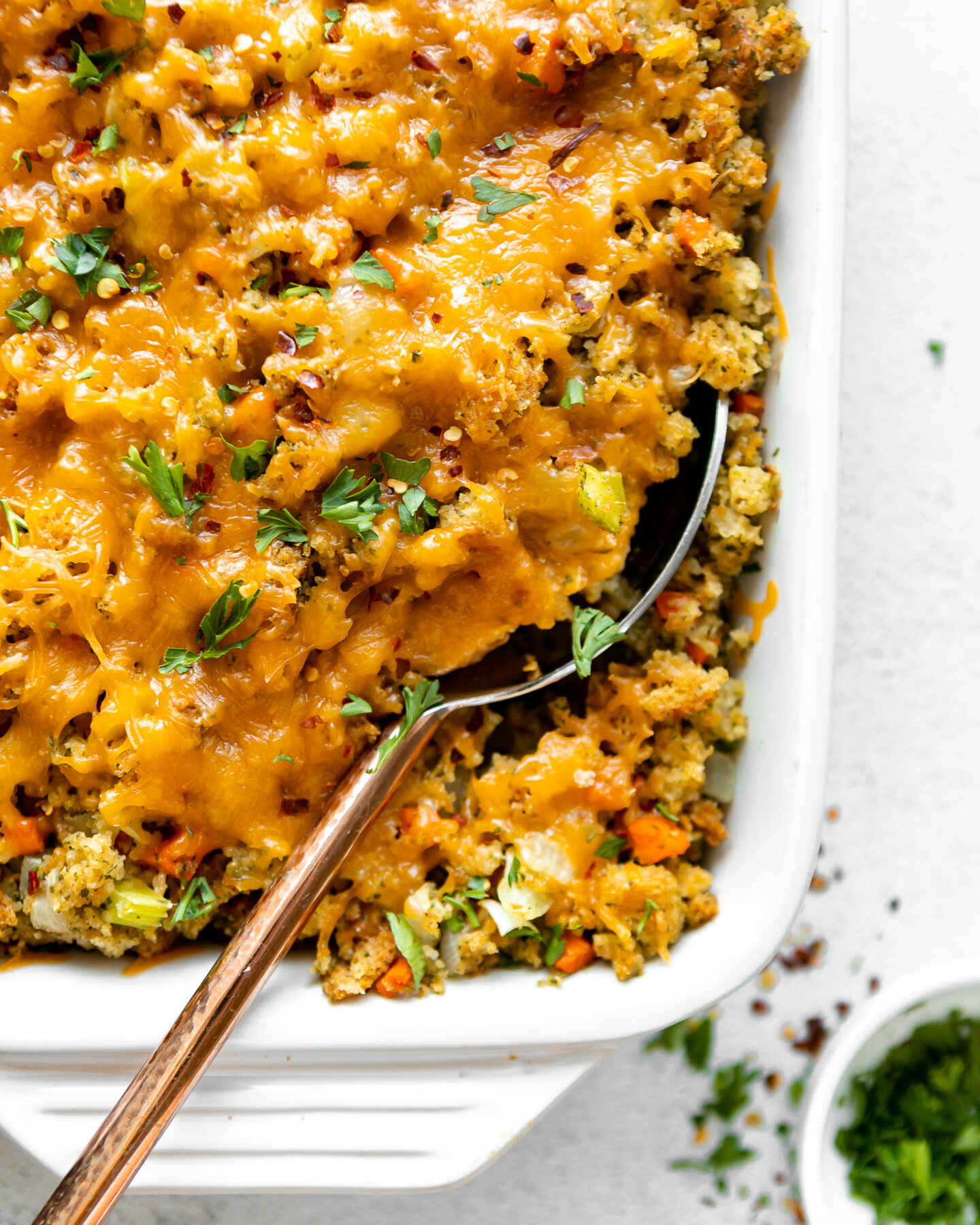 Close up of Chicken Broccoli Stuffing Casserole with a large serving spoon.