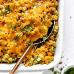 Close up of Chicken Broccoli Stuffing Casserole with a large serving spoon.