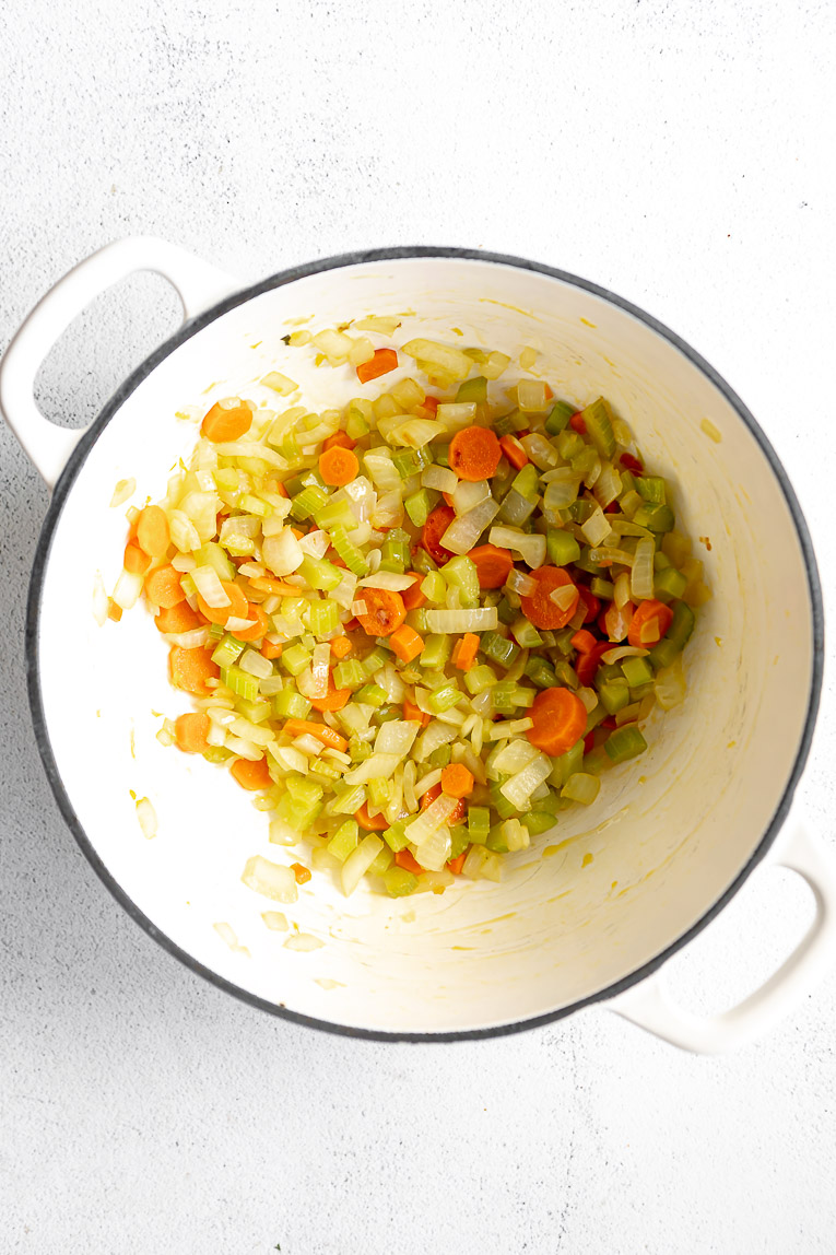 Vegetables being cooked in a dutch oven.