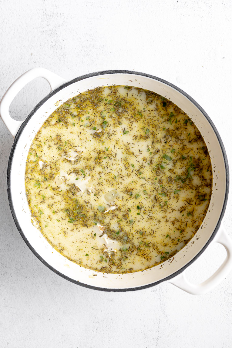 Creamy chicken soup being simmered in a pot.