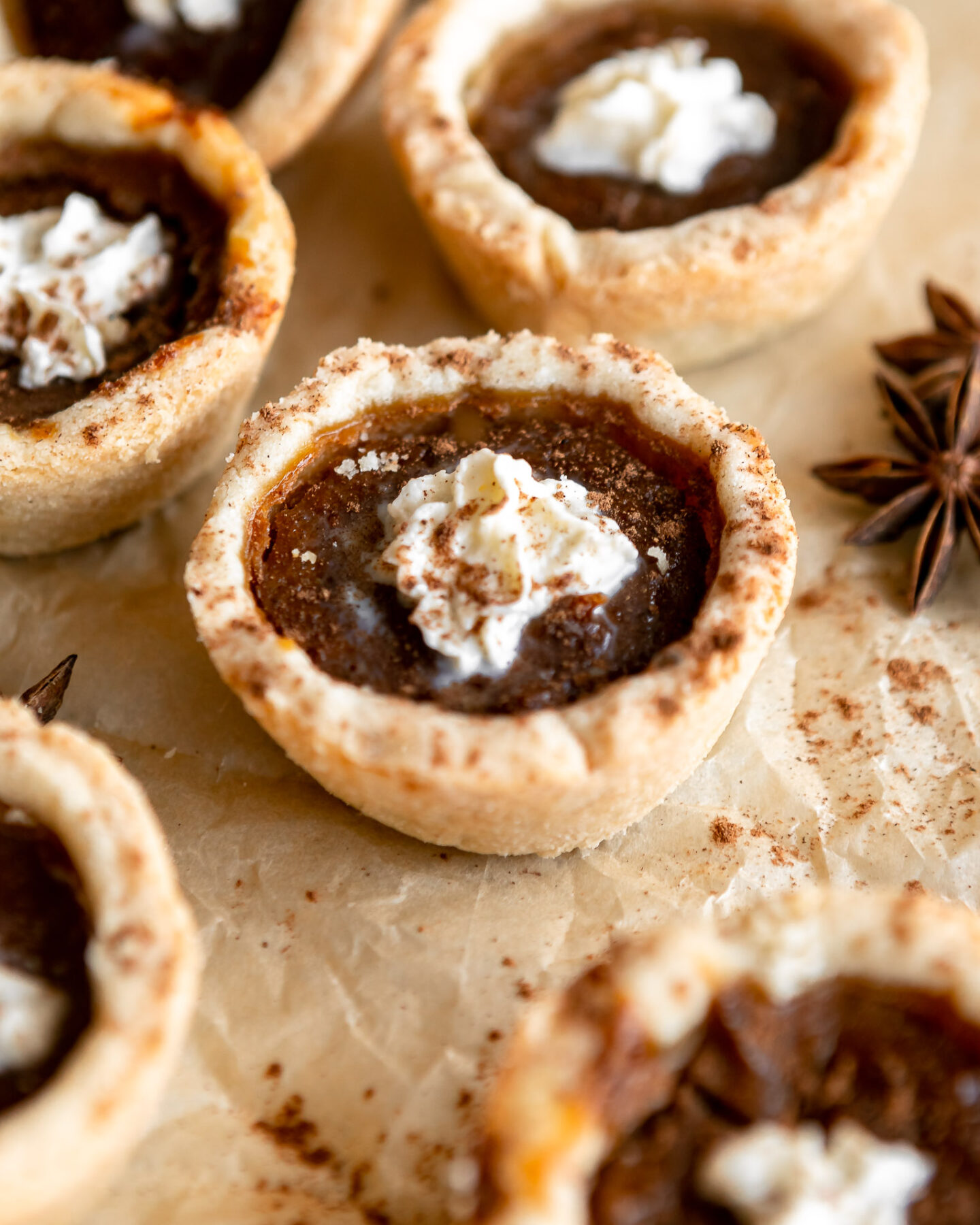 Mini pumpkin pies with whipped cream on top.