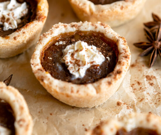 Mini pumpkin pies with whipped cream on top.