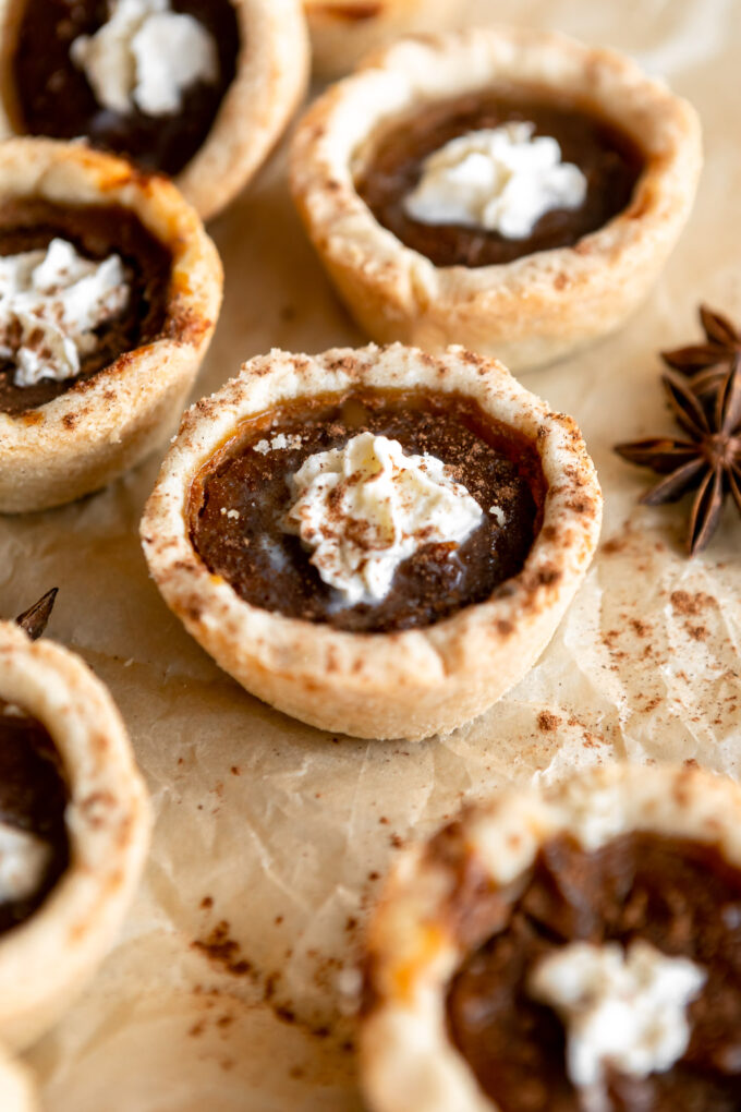 Mini pumpkin pies with whipped cream on top.