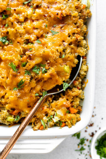 Close up of Chicken Broccoli Stuffing Casserole with a large serving spoon.