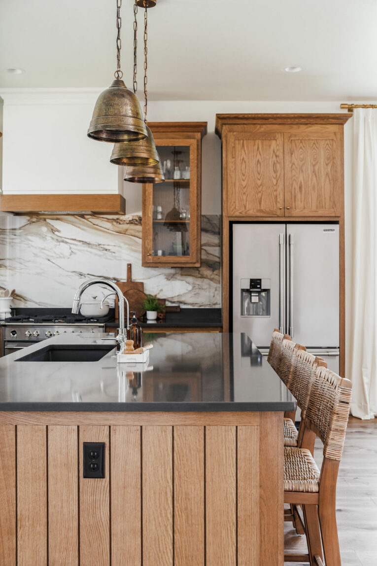 Beautiful modern traditional kitchen with black quartz countertops.