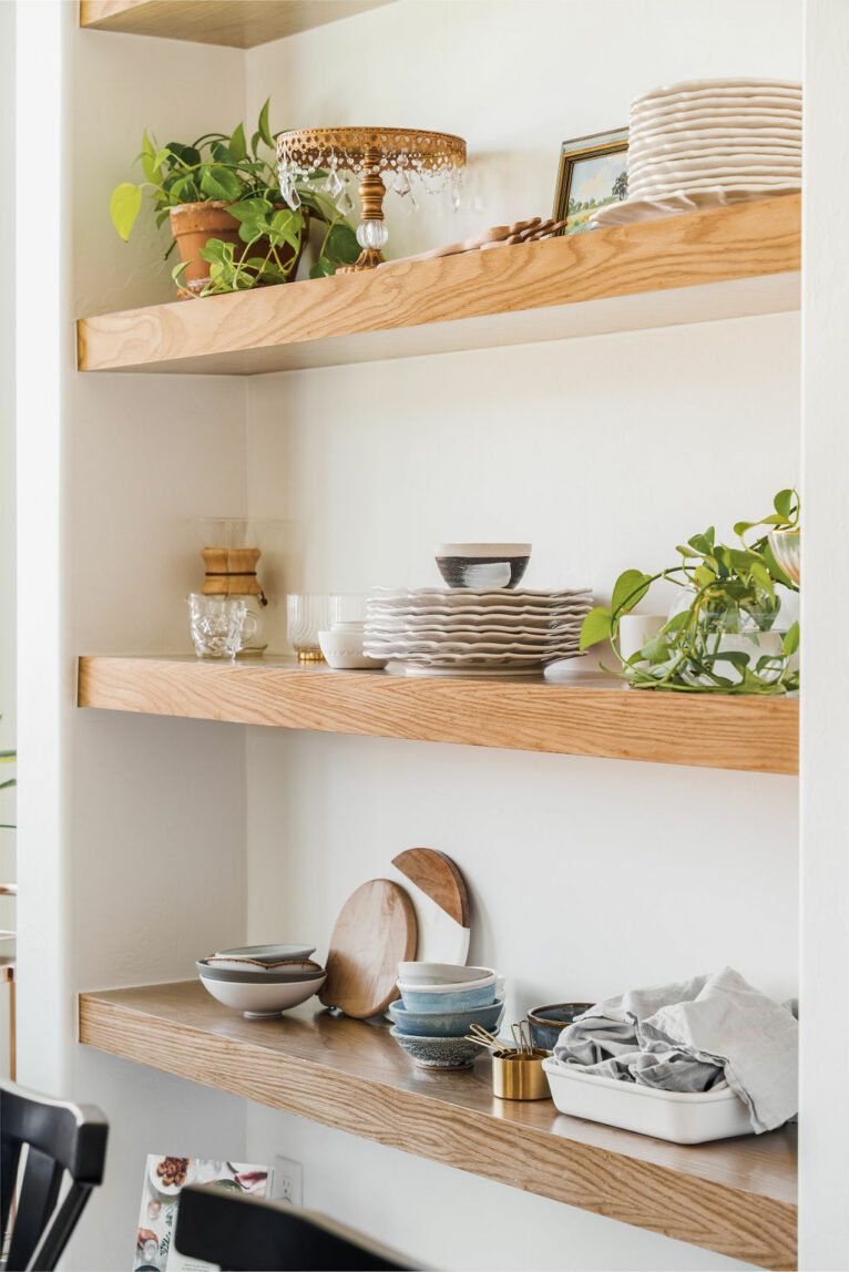 Built-in shelves with dishes and plants.