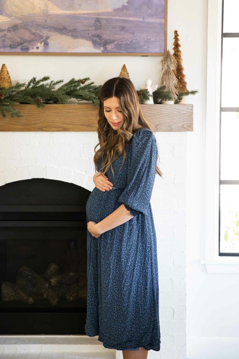 Pregnant mom holding baby belly.