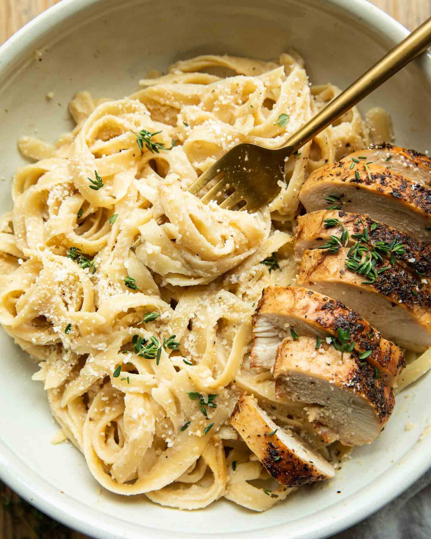 Healthy Chicken Alfredo with Cauliflower Sauce in a bowl with a fork.