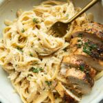 Healthy Chicken Alfredo with Cauliflower Sauce in a bowl with a fork.