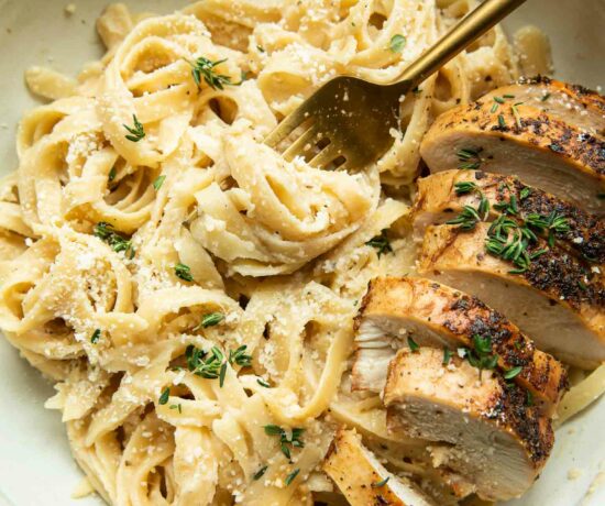 Healthy Chicken Alfredo with Cauliflower Sauce in a bowl with a fork.
