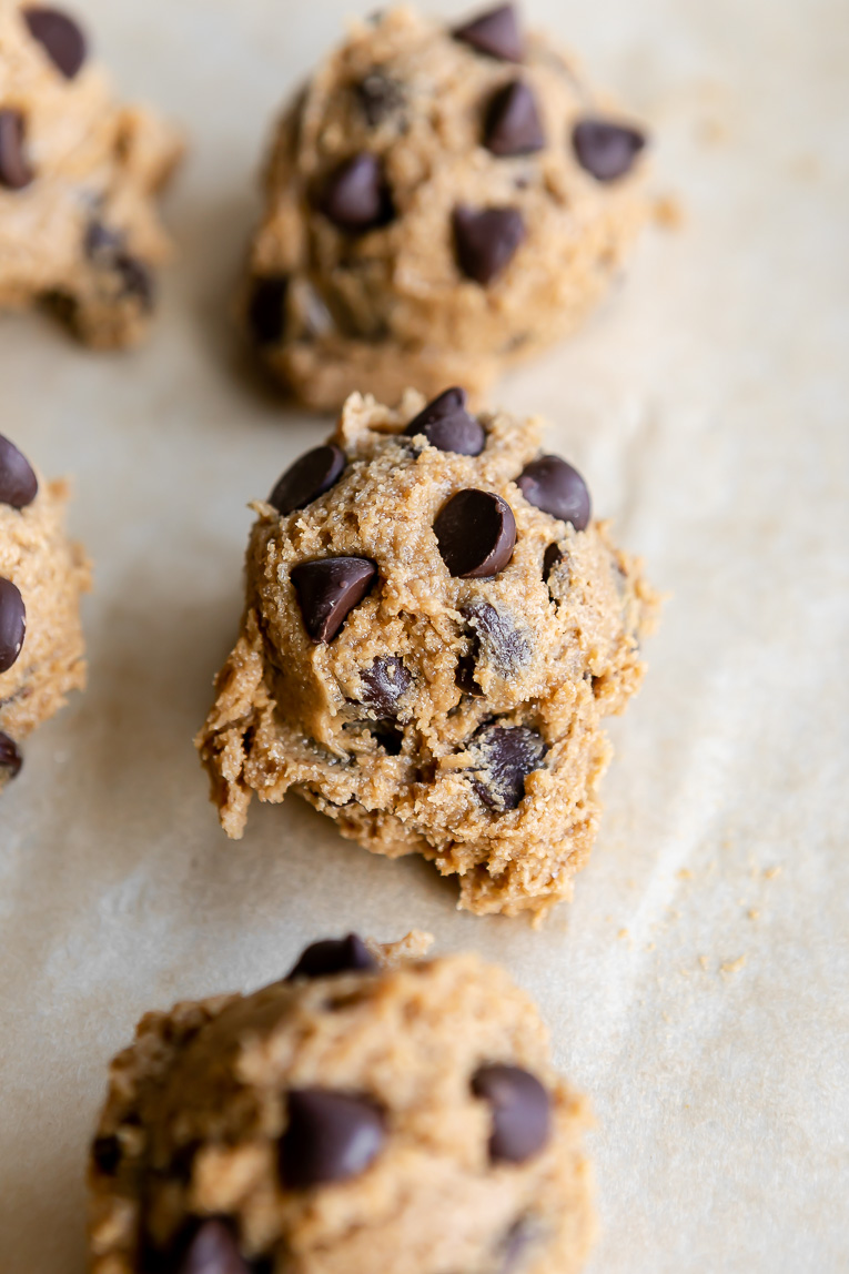Oat Flour Chocolate Chip Cookie Dough scooped on a baking sheet.
