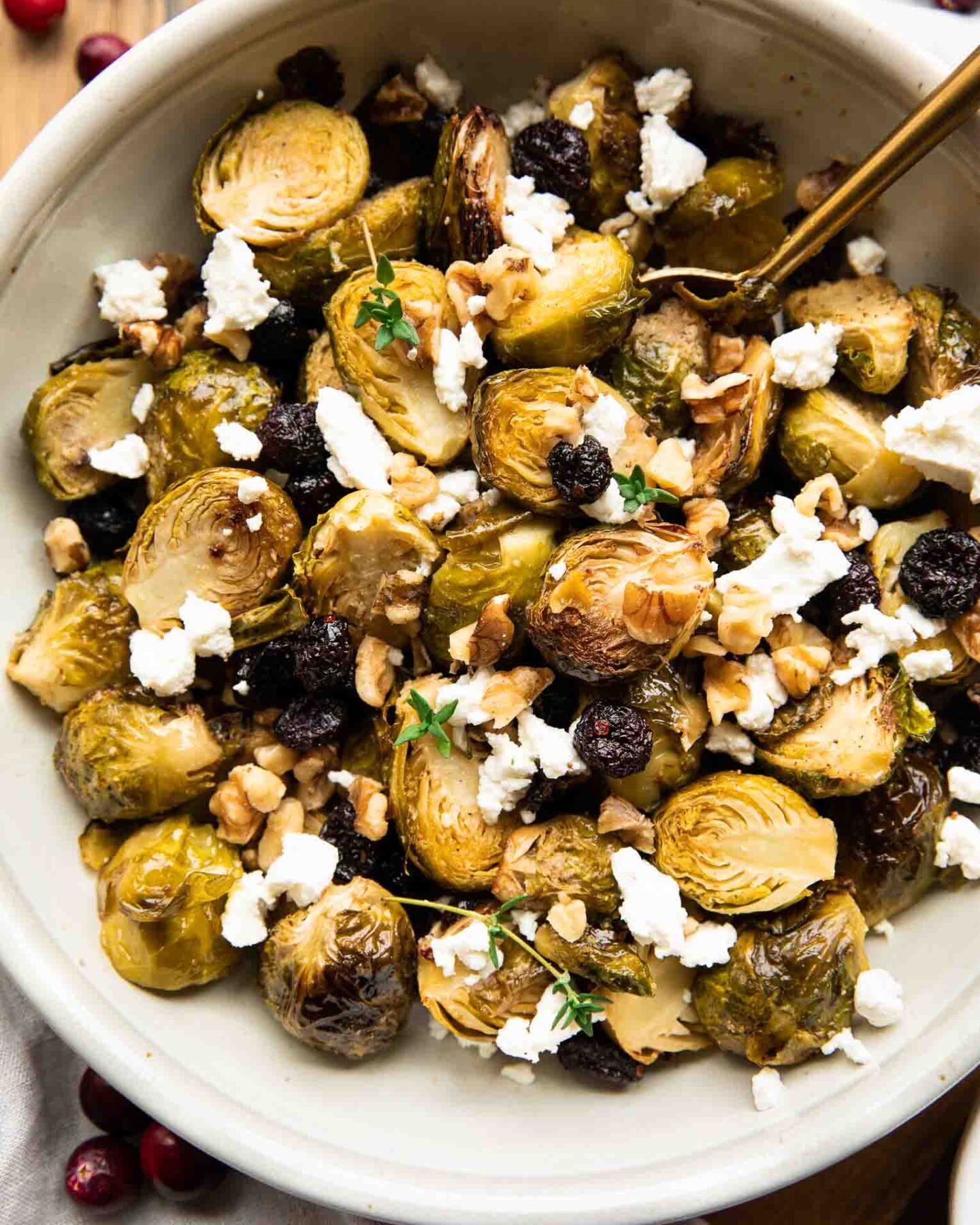 Roasted Brussels Sprouts with Goat Cheese in a bowl with a spoon.