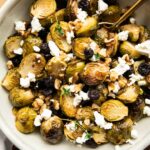 Roasted Brussels Sprouts with Goat Cheese in a bowl with a spoon.
