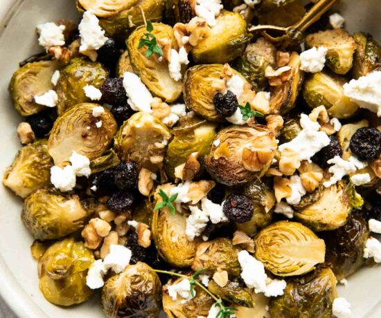 Roasted Brussels Sprouts with Goat Cheese in a bowl with a spoon.