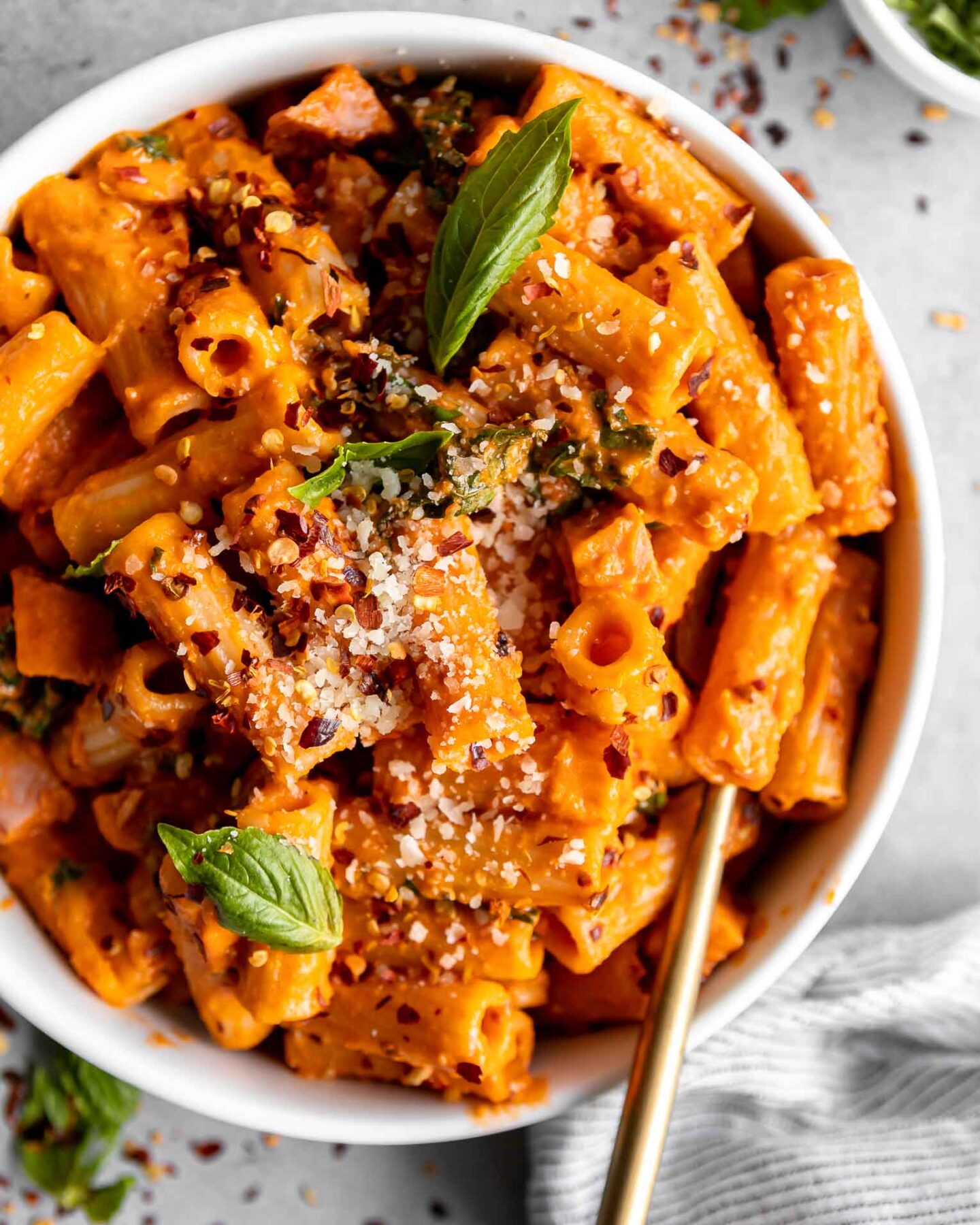Spicy Vodka Pasta with ham and a fork in a bowl.