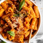 Spicy Vodka Pasta with ham and a fork in a bowl.