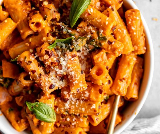 Spicy Vodka Pasta with ham and a fork in a bowl.