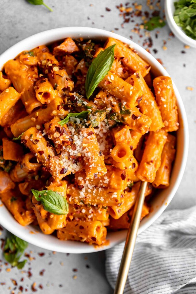 Spicy Vodka Pasta with ham and a fork in a bowl.