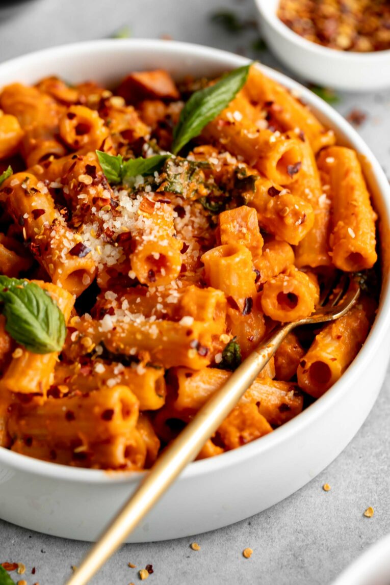 Close up of Spicy Vodka Pasta with ham and kale.