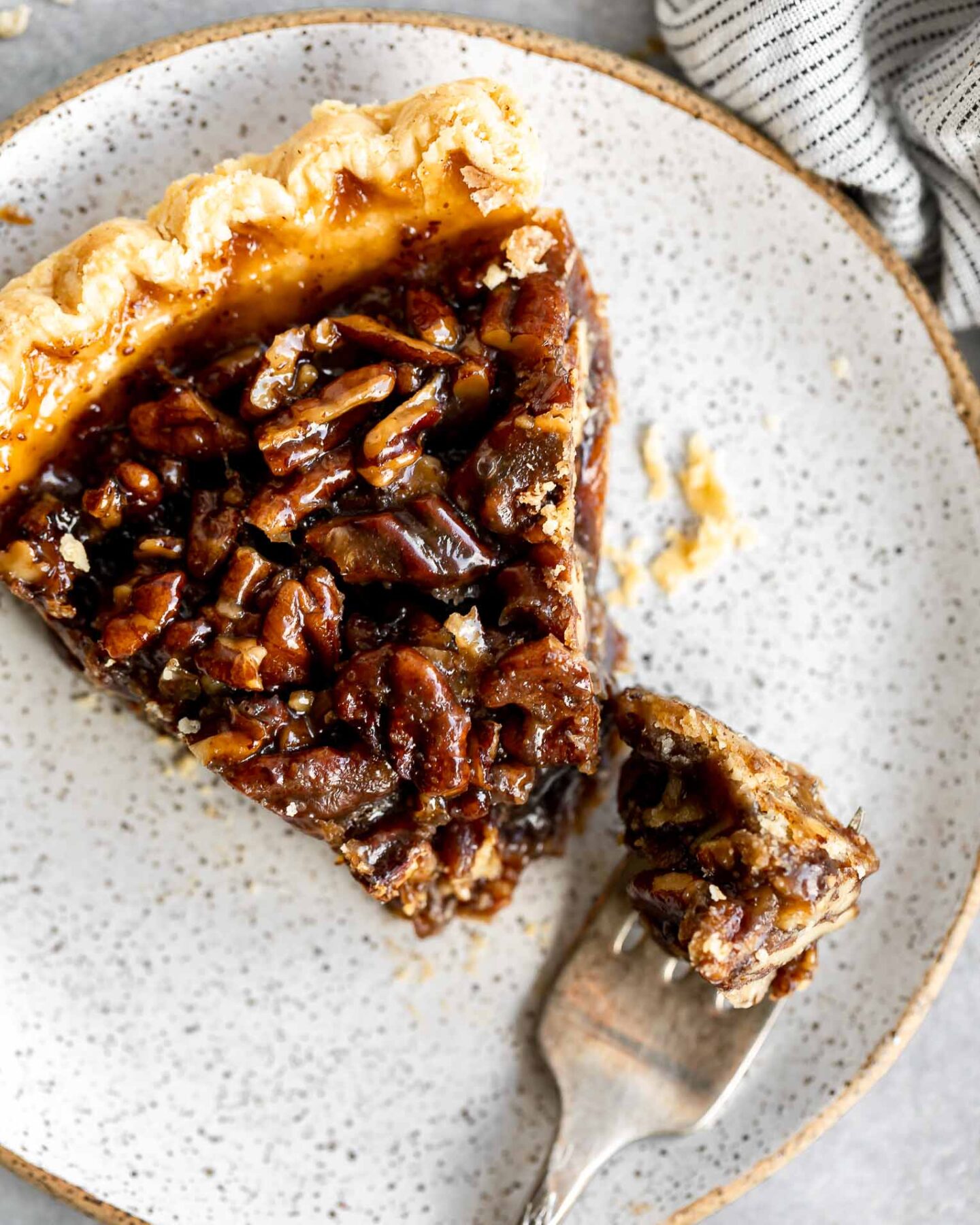 Top photo of vegan pecan pie slice on a plate.