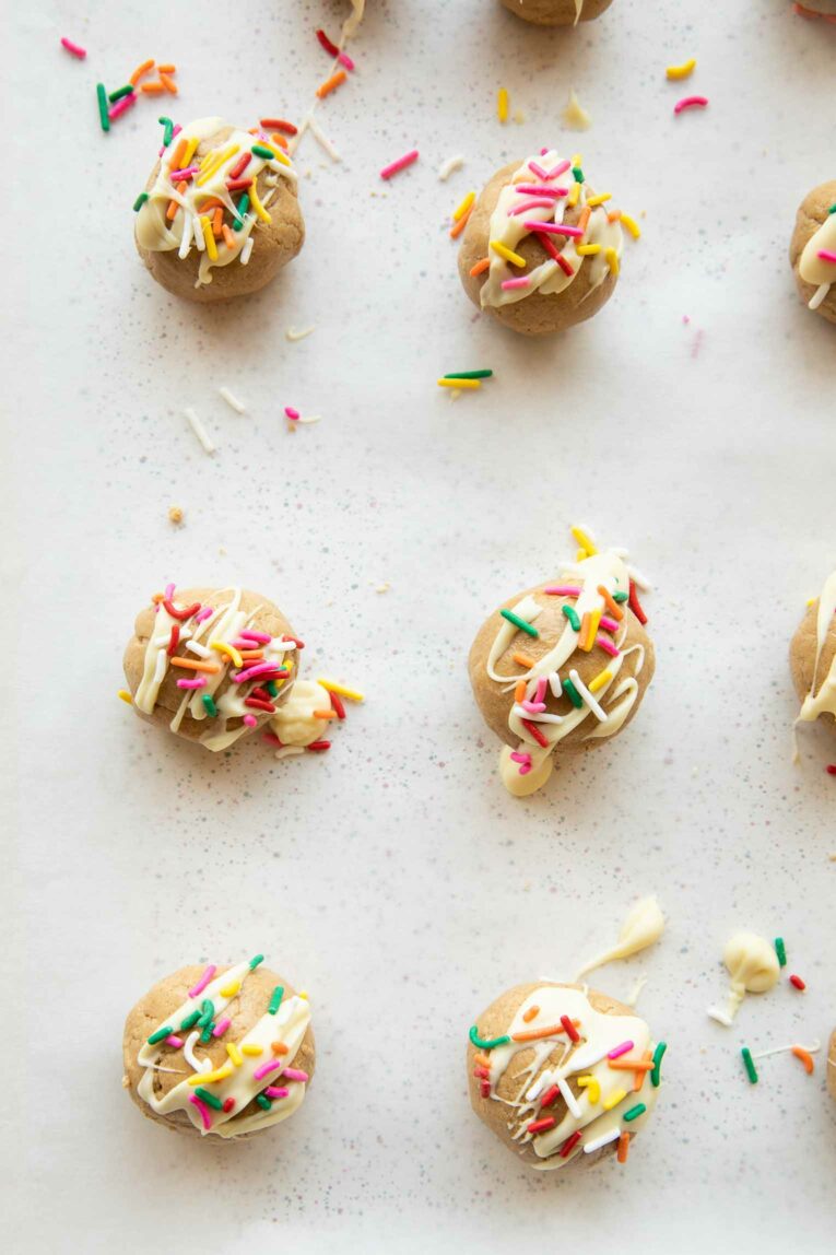 Birthday cake protein bites on a baking sheet.