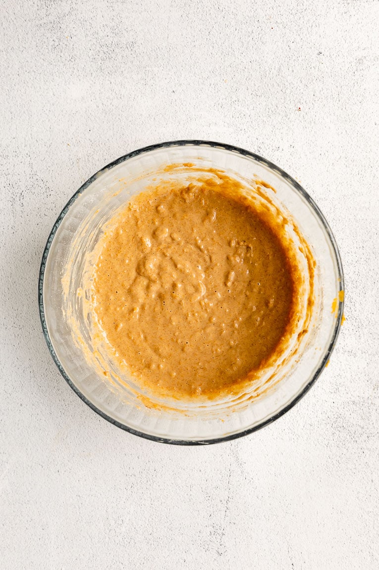Butternut squash pancake batter in a large mixing bowl.