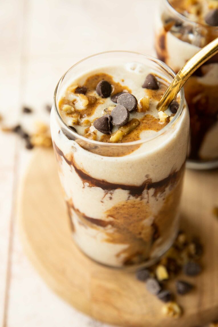 Angled photo of chunky monkey protein smoothie in a glass.