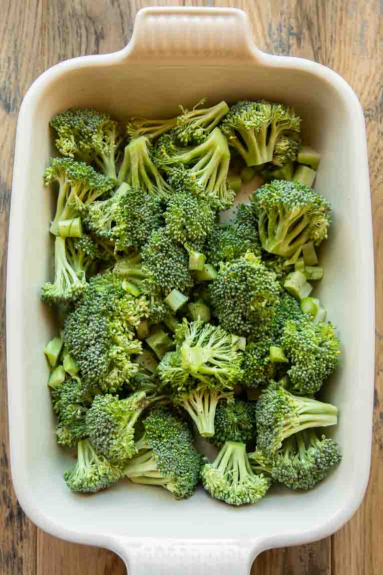 Broccoli being roasted in a pan.