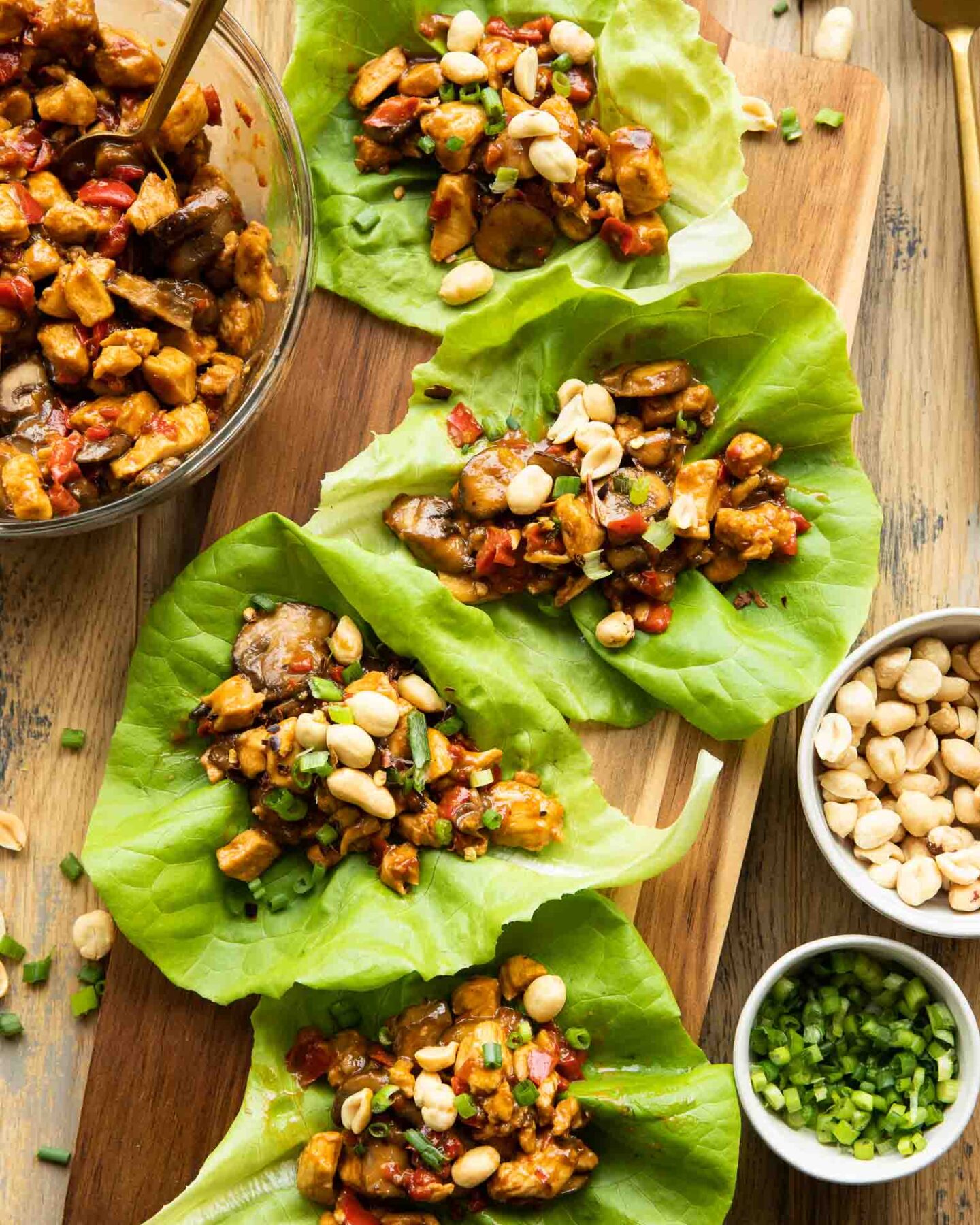 Healthy Thai Chicken Lettuce Wraps recipe on a wood cutting board.