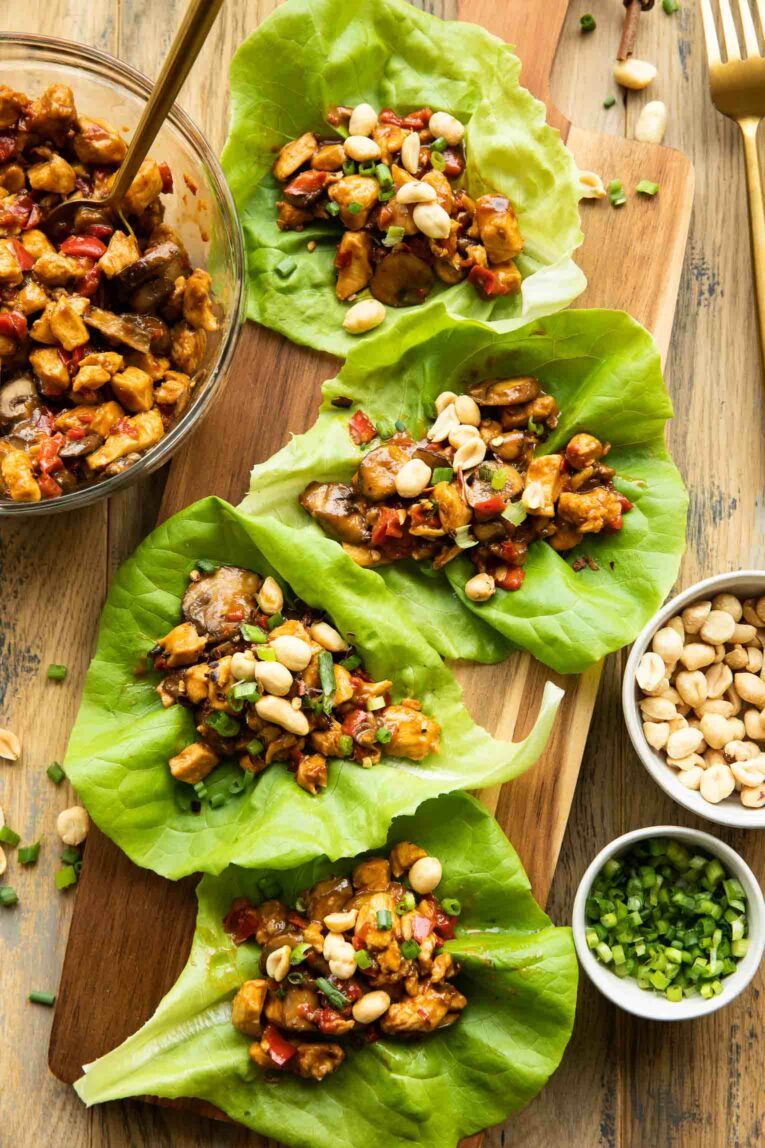 Healthy Thai Chicken Lettuce Wraps recipe on a wood cutting board.