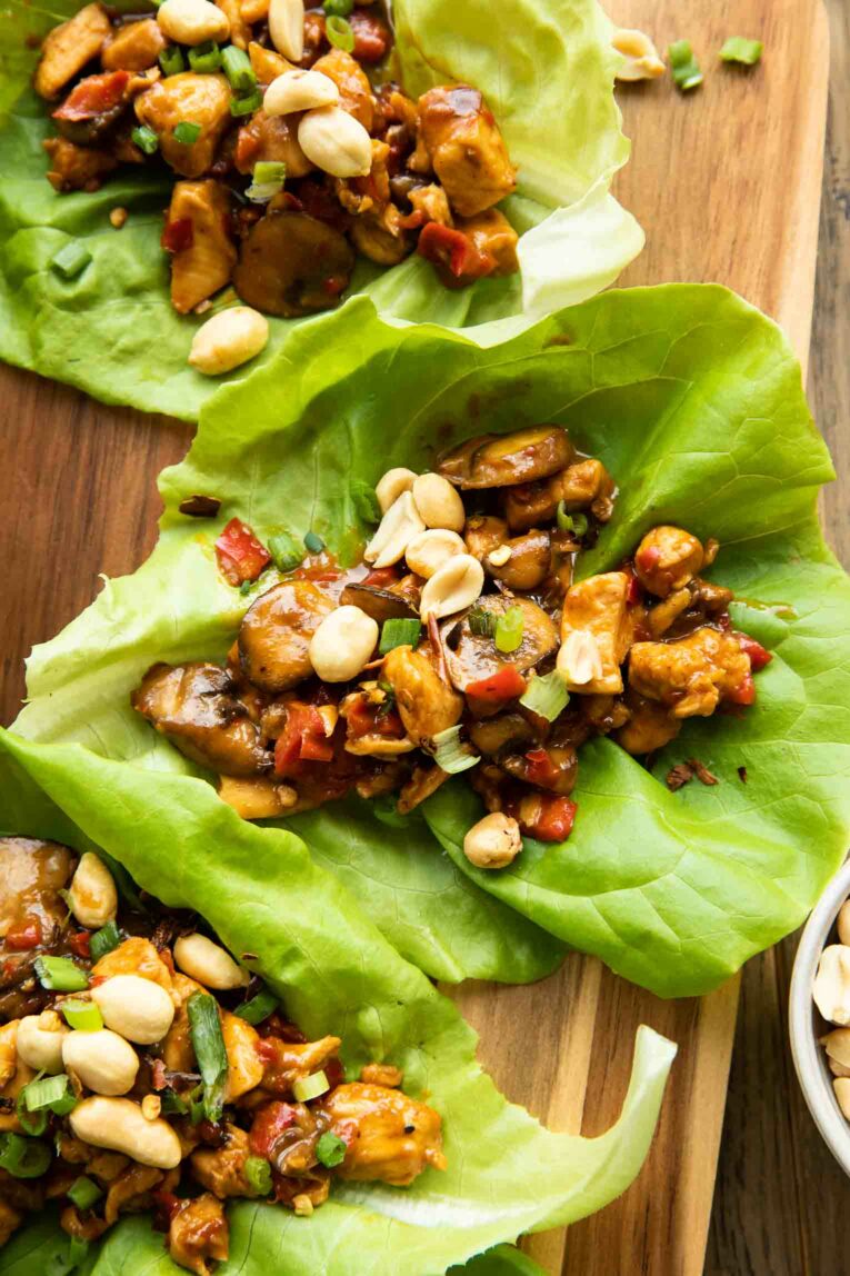 Healthy Thai Chicken Lettuce Wrap with peanuts, mushrooms, and green onions.