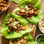 Close up of Healthy Thai Chicken Lettuce Wraps on a cutting board.