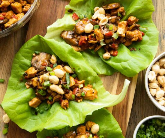 Close up of Healthy Thai Chicken Lettuce Wraps on a cutting board.