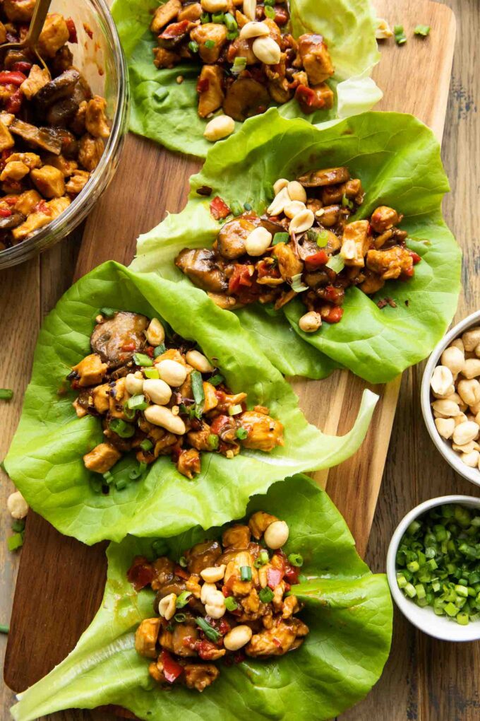 Close up of Healthy Thai Chicken Lettuce Wraps on a cutting board.