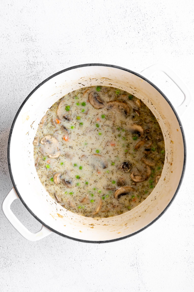 Creamy sauce mixed into cooked vegetables.