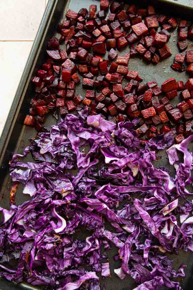 Roasted beets and roasted red cabbage on a sheet pan.