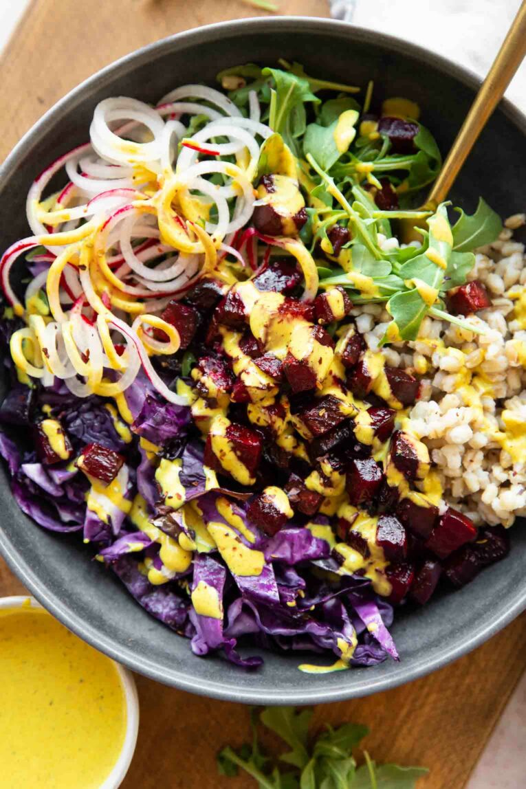 Roasted beets bowls with whole grains and turmeric tahini sauce.