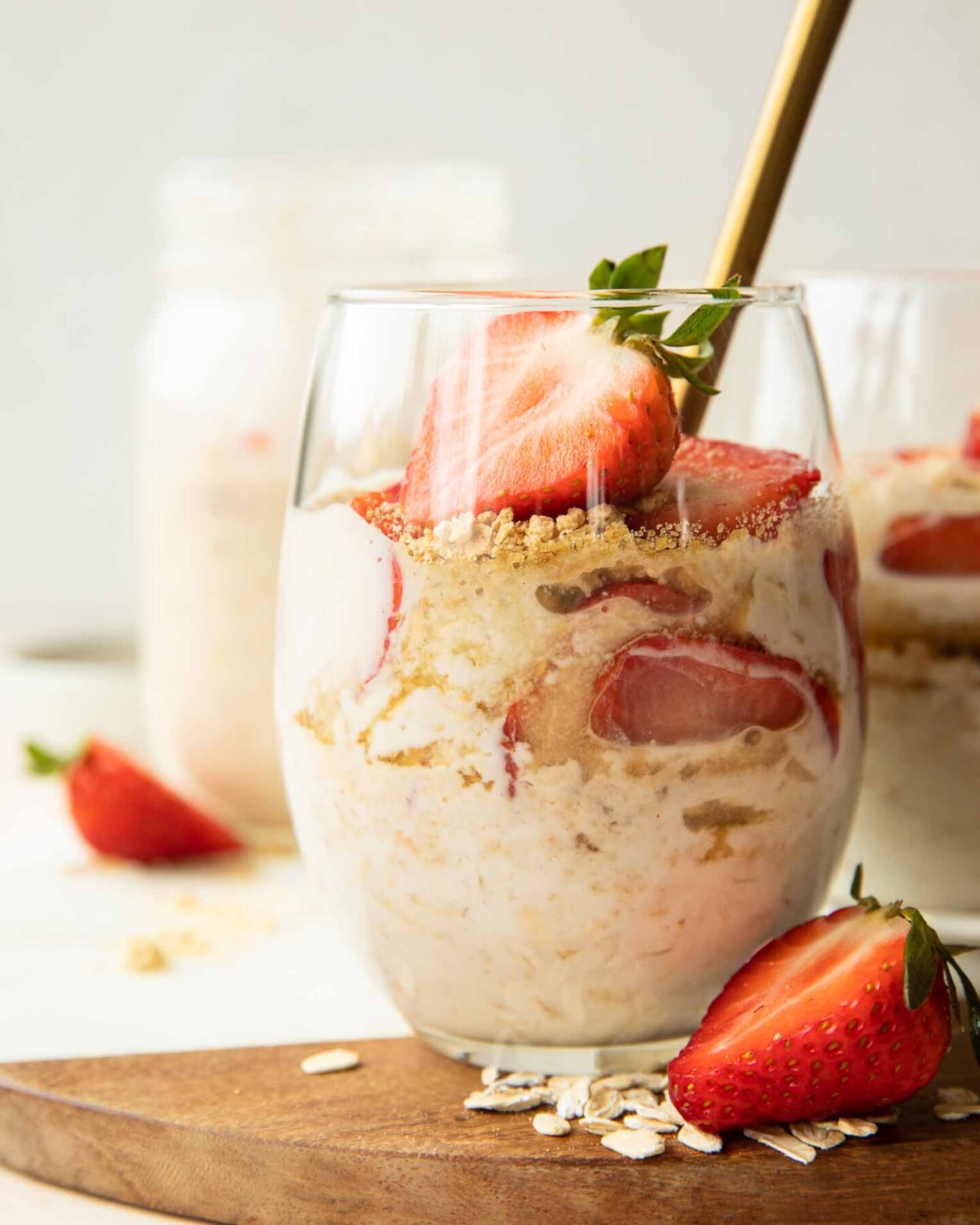 Strawberry Cheesecake Overnight Oats with fresh strawberries in a glass.