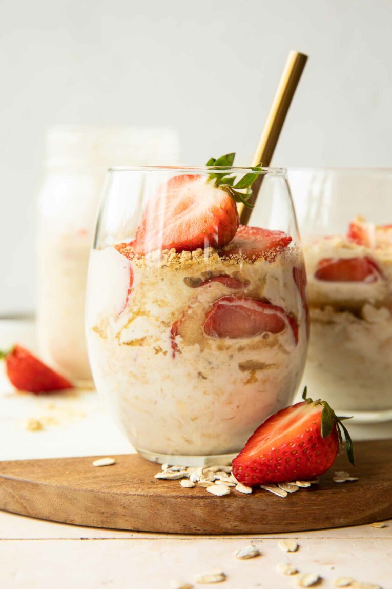 Strawberry Cheesecake Overnight Oats in a jar with a spoon.