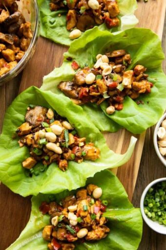 Close up of Healthy Thai Chicken Lettuce Wraps on a cutting board.