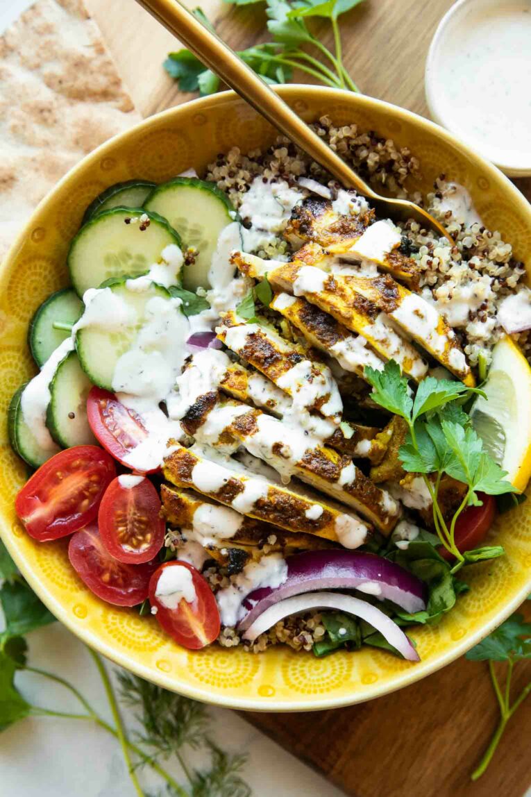 Chicken Shawarma Grain Bowls recipe with a fork and tzatziki sauce.