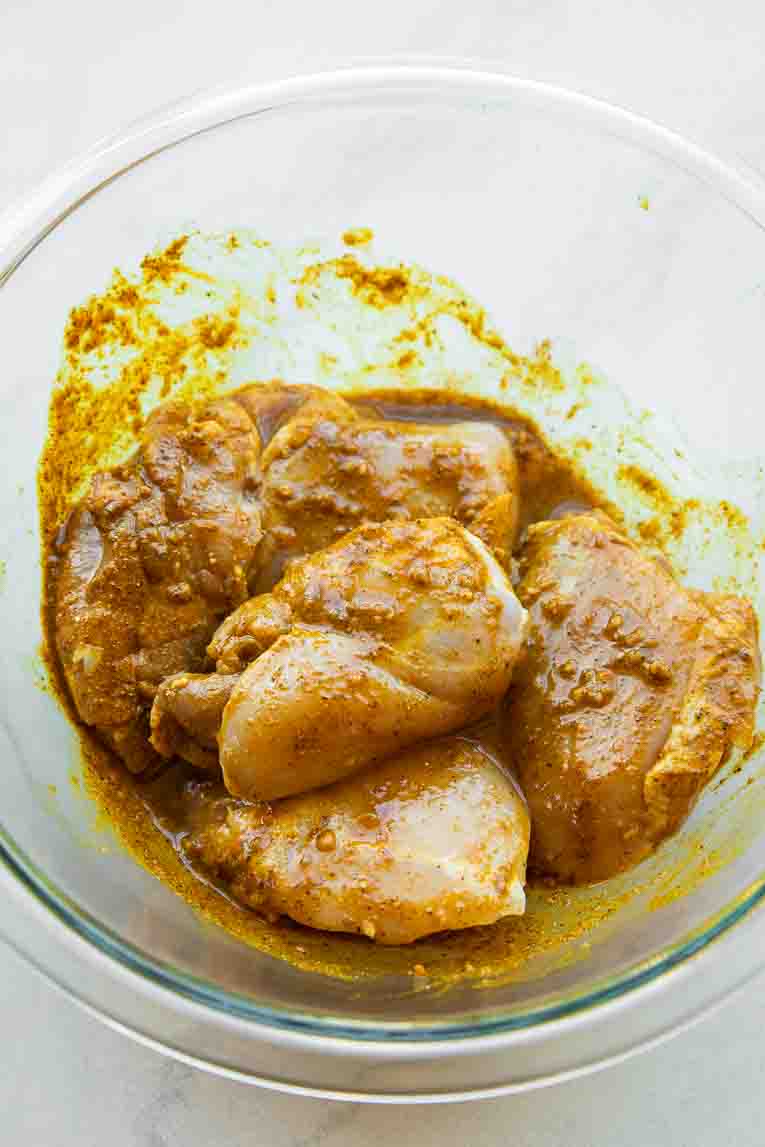 Chicken being marinated.