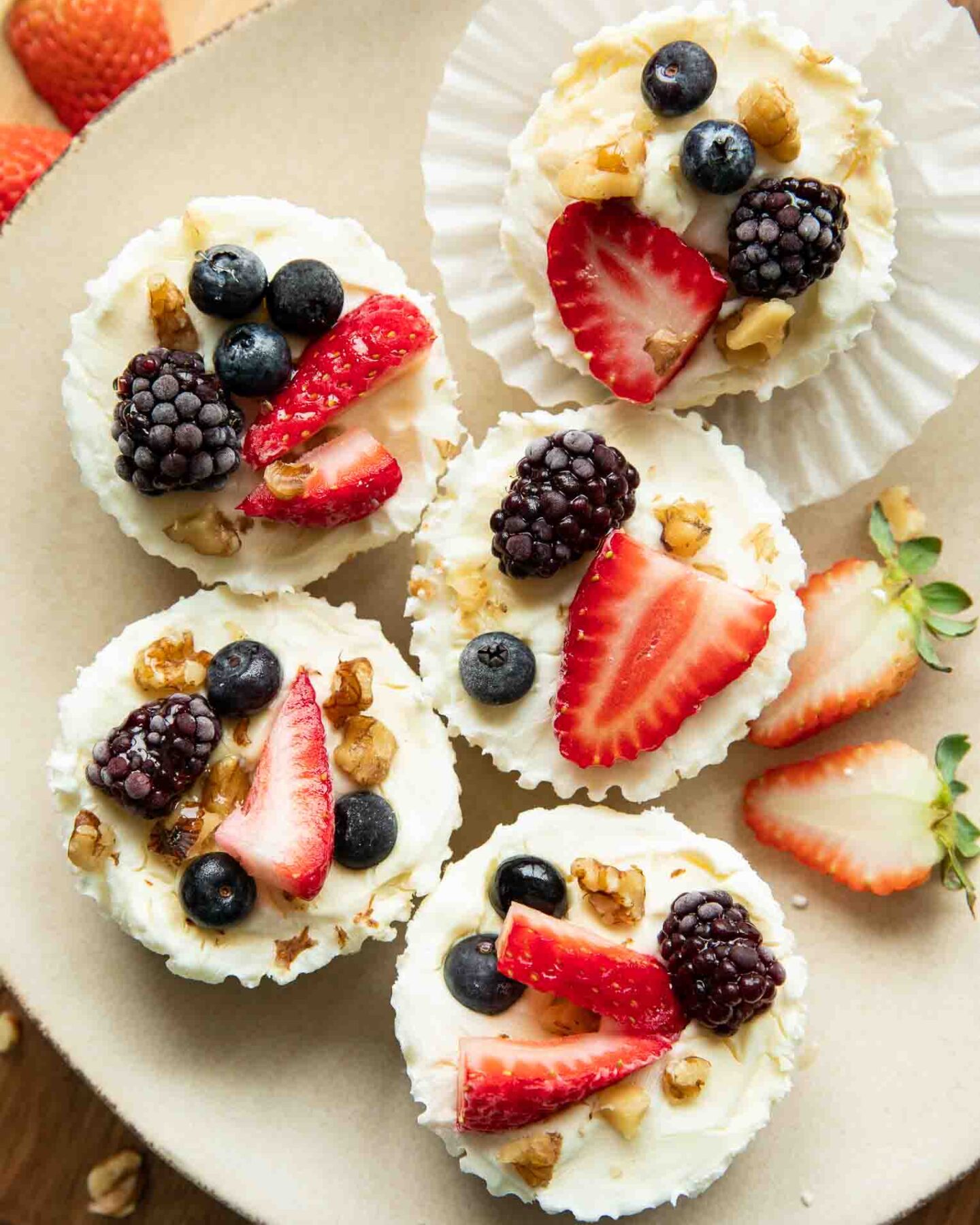 Frozen Yogurt Granola Cups topped with fruit, nuts, and honey.