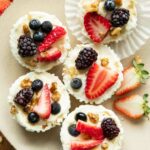 Frozen Yogurt Granola Cups topped with fruit, nuts, and honey.